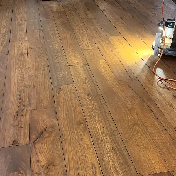 Stained wooden floorboards with a rich dark oil finish in a London living room