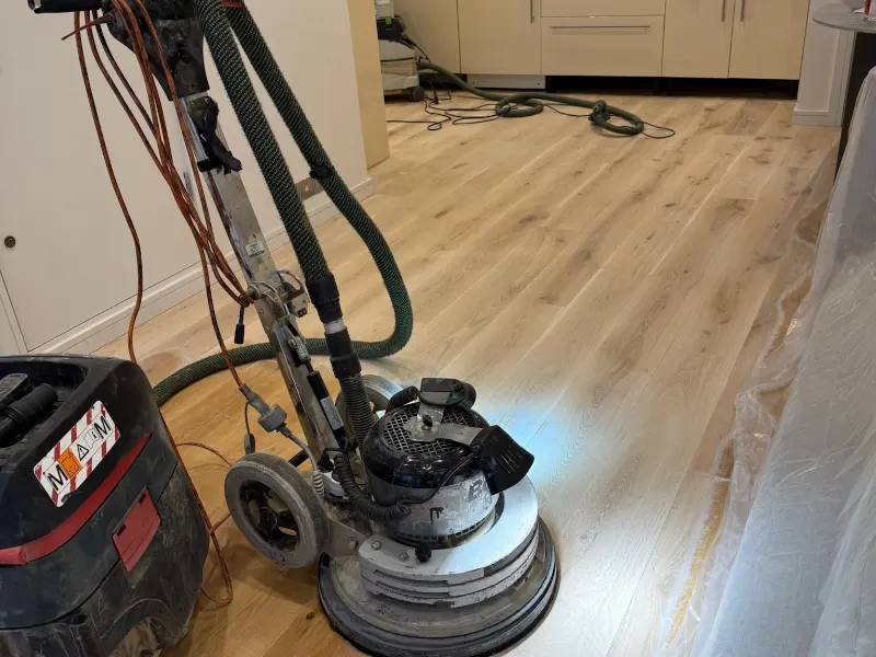 Bona FlexiSand rotary sanding machine with vacuum system in use during a dust-free wood floor sanding project in London