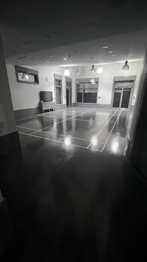 Refinished sports court flooring in Stratford with fresh white line markings.