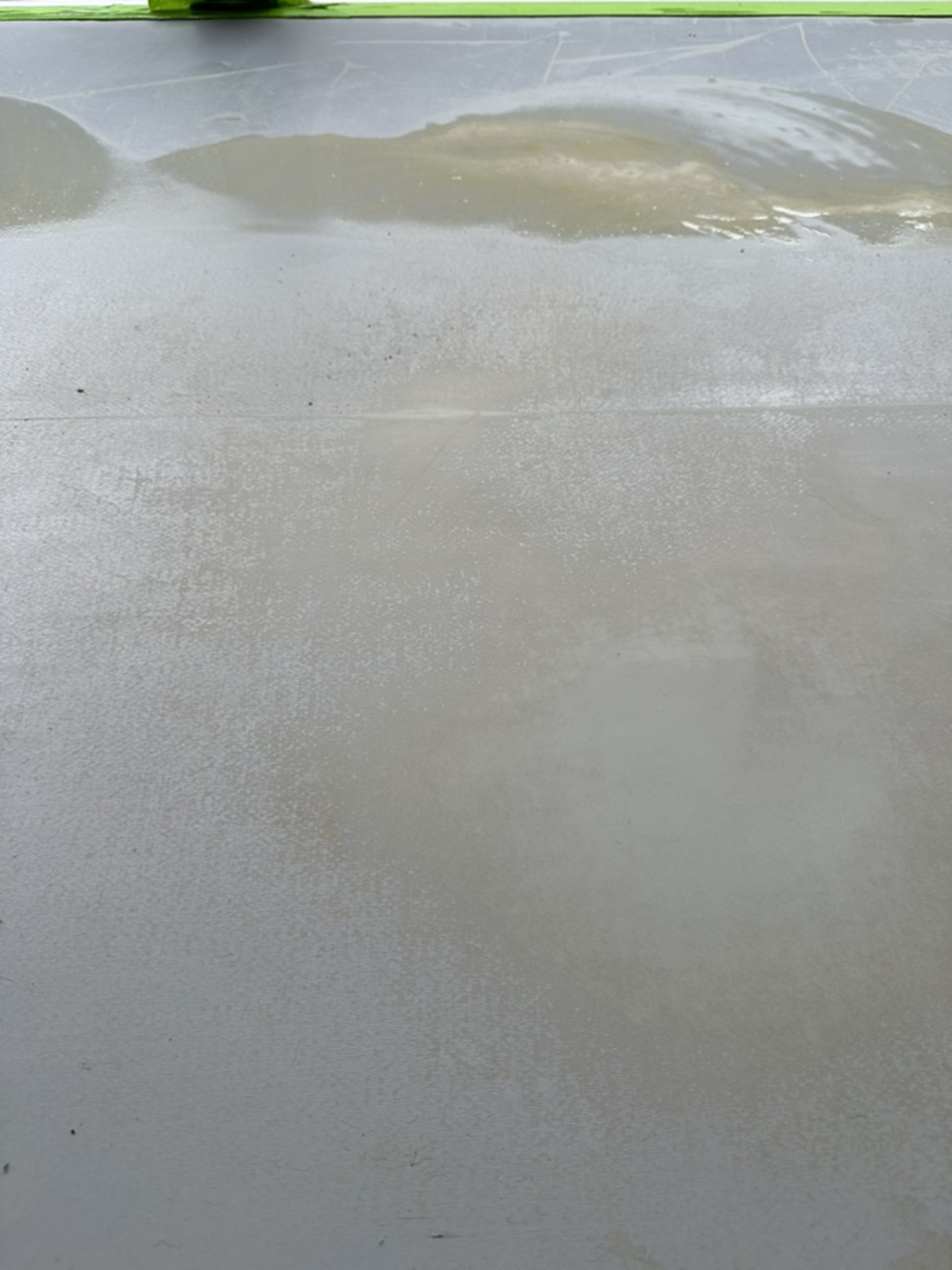 Moisture reaction visible in a resin floor during repair work in Kennington, South London