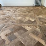 sanding oak parquet flooring with belt sander
